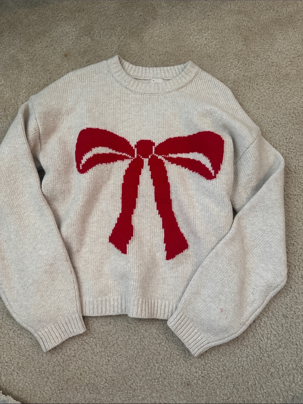a new day Cream Sweater with Red Bow Graphic